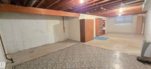 Spacious unfinished basement offering exposed ceiling joists and concrete flooring - 5304 49 Street, Two Hills, AB - Indoor Photo Showing Basement