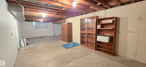 Unfinished basement with exposed ceiling joists and concrete flooring - 5304 49 Street, Two Hills, AB - Indoor Photo Showing Basement