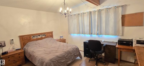 Room featuring light-colored walls and wood-finish flooring - 5304 49 Street, Two Hills, AB - Indoor Photo Showing Bedroom