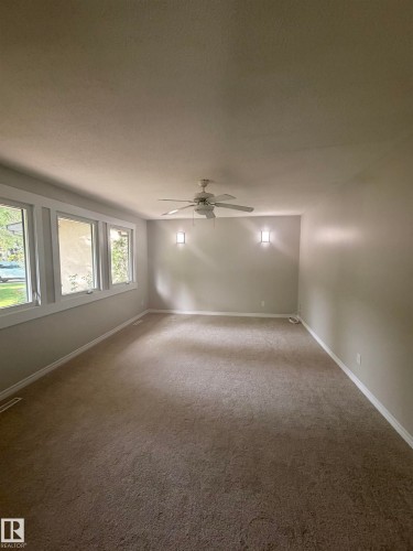 Spacious room featuring neutral carpeting and light-toned walls - 8 Savoy Place, St. Albert, AB 