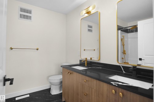 Dual vanity with wood-finish cabinetry and gold-tone hardware - 8523 Mayday Run, Edmonton, AB 