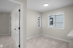 Carpeted room with neutral wall tones and white trim - 