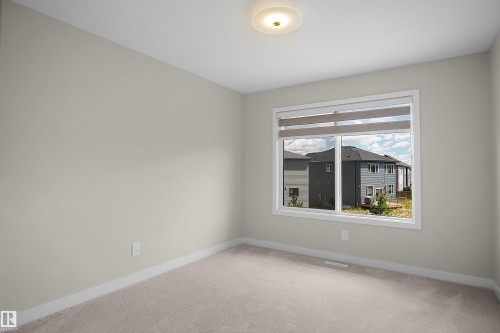 Neutral-toned carpeting paired with light wall paint - 8523 Mayday Run, Edmonton, AB 