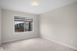 Carpeted room with neutral painted walls and white baseboards - 