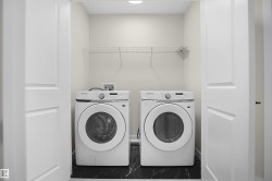 Dedicated laundry area featuring a front-loading washer and dryer set - 