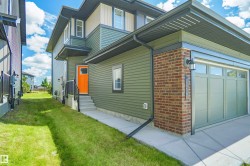 Contemporary exterior featuring olive green siding and brick accents - 