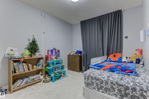 Light gray walls complement the textured white ceiling and light-colored carpeting - 1311 30 Avenue, Edmonton, AB 