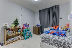 Light gray walls complement the textured white ceiling and light-colored carpeting - 