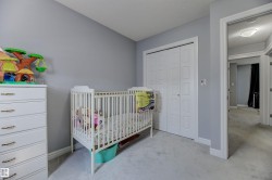 Interior room featuring light gray wall paint, white baseboards, and light-toned carpeting - 