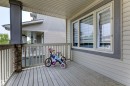 Covered porch featuring wood-finish decking and a railing system - 1311 30 Avenue, Edmonton, AB 