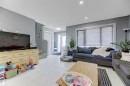 Spacious living area featuring light gray walls and white tile flooring - 1311 30 Avenue, Edmonton, AB 