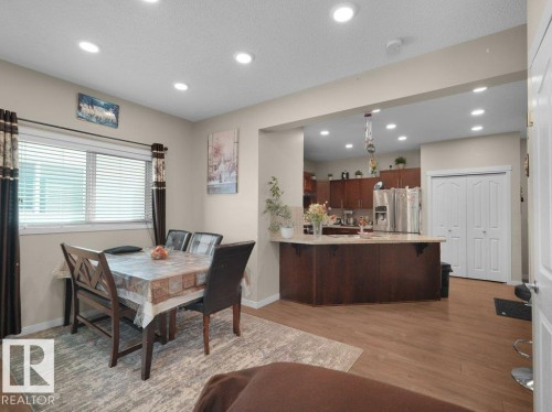 Dining area with wood-finish flooring and recessed lighting - 1419 27 Av, Edmonton, AB 