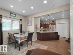 Dining area with wood-finish flooring and recessed lighting - 