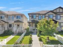 Two-story duplex featuring neutral-toned siding and stone accents - 1419 27 Av, Edmonton, AB 