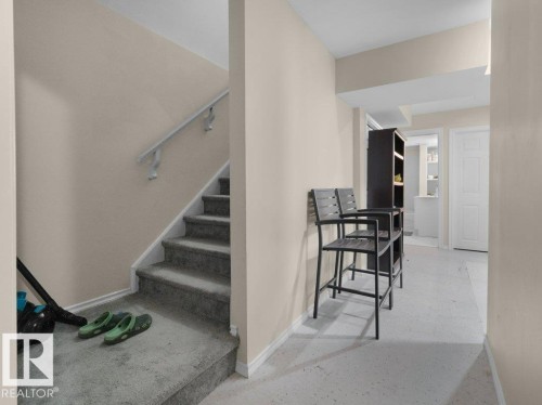 Carpeted staircase with white handrail and base trim - 1419 27 Av, Edmonton, AB 