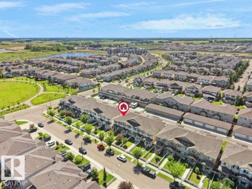 Aerial perspective of a developed residential community featuring rows of townhomes and detached properties - 1419 27 Av, Edmonton, AB 