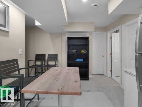 Finished interior space featuring light beige walls and recessed lighting - 1419 27 Av, Edmonton, AB 
