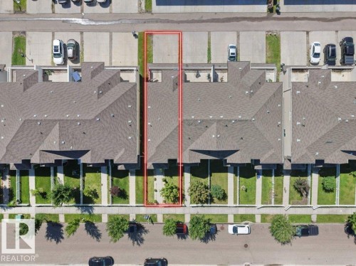 Aerial view of a residential property with a gabled roof and a private concrete patio - 1419 27 Av, Edmonton, AB 
