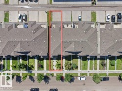 Aerial view of a residential property with a gabled roof and a private concrete patio - 