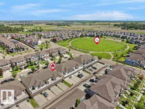 Aerial view showcasing a residential community with numerous detached homes and townhome-style properties - 1419 27 Av, Edmonton, AB 