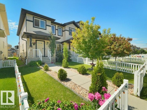 Two-story facade with light-colored siding and dark trim accents - 1419 27 Av, Edmonton, AB 