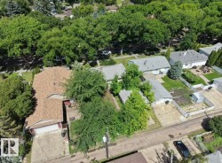 Aerial perspective highlighting the property with surrounding mature trees - 