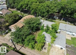Brown shingle roof home with attached two-car garage and concrete driveway - 