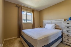 Carpeted room featuring a double-paned window with curtain rod and drapes, neutral wall color, and white trim - 