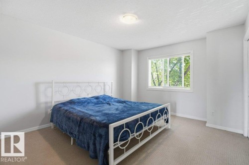 Bedroom featuring light-colored walls and neutral-toned carpet - 30 1404 Hermitage Road, Edmonton, AB 