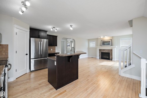 178 Woodbend Way, Fort Saskatchewan, AB - Indoor Photo Showing Kitchen With Fireplace