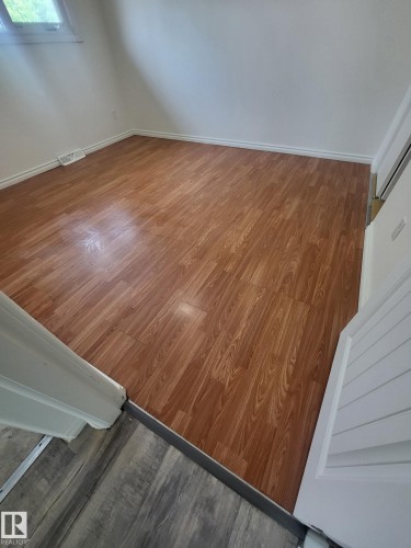 Room featuring wood-finish flooring, white baseboards, and light-toned walls - 10220 107 Street, Westlock, AB - Indoor Photo Showing Other Room