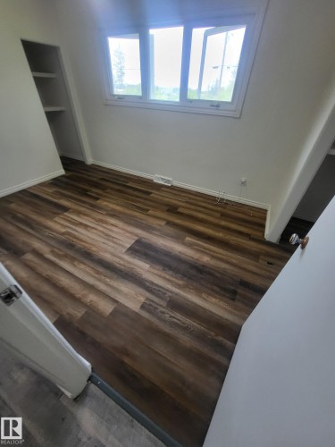 Room featuring wood-finish flooring, a white trim package, and white painted walls - 10220 107 Street, Westlock, AB - Indoor Photo Showing Other Room
