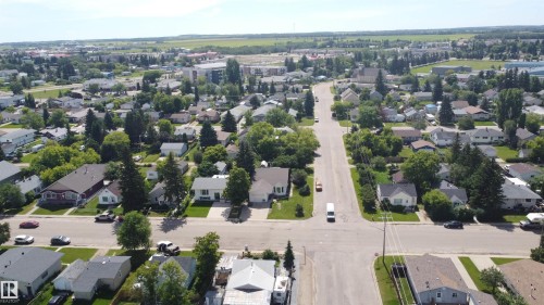 Aerial perspective of a developed residential area featuring tree-lined streets and established homes - 10220 107 Street, Westlock, AB - Outdoor With View