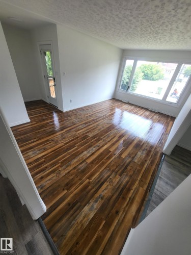 Spacious interior featuring wide-plank wood-finish flooring and crisp white walls - 10220 107 Street, Westlock, AB - Indoor Photo Showing Other Room