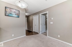 Carpeted flooring extending into a hallway with contrasting dark tile - 