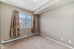 Room featuring wall-to-wall carpeting, light neutral wall paint, and baseboard heating - 