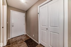 Entryway featuring a white paneled door, ceramic tile flooring, and a flush mount ceiling light - 