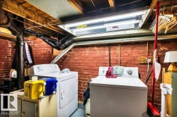 Dedicated laundry area featuring a top-load washing machine and front-load dryer - 