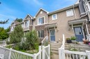 Townhome exterior featuring gabled roofs, horizontal siding, and stone veneer accents - 53 3625 144 Avenue, Edmonton, AB 