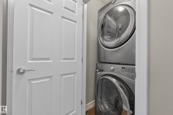 Space-saving stacked washer and dryer unit with a sleek silver finish and front-loading design - 