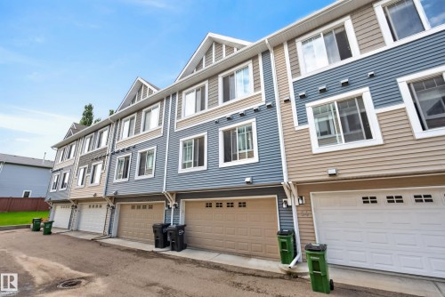 Row of townhomes featuring multi-toned siding, white trim, and multiple windows - 53 3625 144 Avenue, Edmonton, AB 
