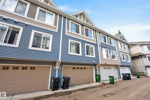 Townhome exterior featuring blue and tan siding with white trim - 53 3625 144 Avenue, Edmonton, AB 
