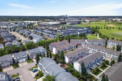 Aerial overview of a residential neighborhood featuring detached homes and multi-level townhouses - 