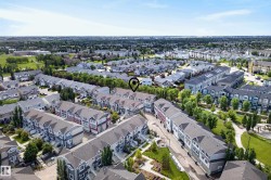 Aerial perspective showcasing a residential community with numerous townhome-style properties - 