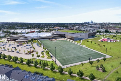 Expansive outdoor sports field with artificial turf, surrounded by green parkland - 53 3625 144 Avenue, Edmonton, AB 