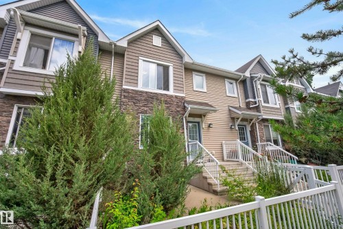 Two-story townhome featuring multi-toned siding, stone accents, and a gabled roofline - 53 3625 144 Avenue, Edmonton, AB 