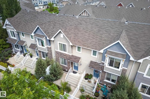 Townhome exterior featuring varied siding materials including horizontal siding and stone veneer accents - 53 3625 144 Avenue, Edmonton, AB 
