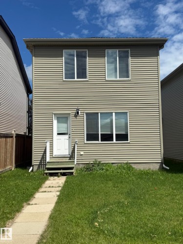 Two-story residence featuring light beige horizontal siding - 8305 Ellis Crescent Nw, Edmonton, AB 