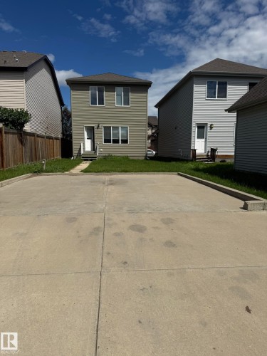Two-story residence featuring light green siding and a dark shingle roof - 8305 Ellis Crescent Nw, Edmonton, AB 