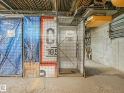 Secure storage unit featuring a metal mesh door and concrete flooring - 